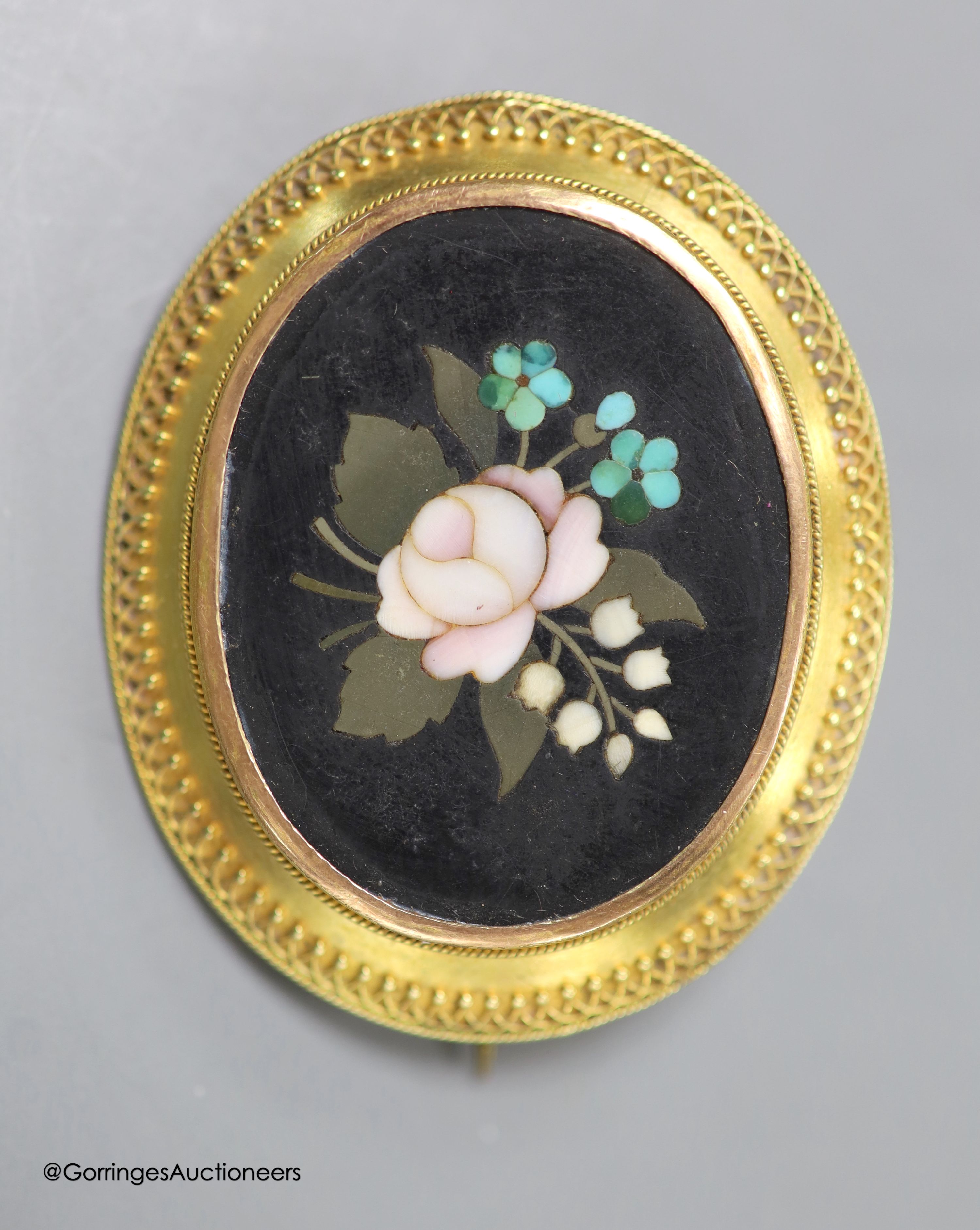 A cased Victorian yellow metal and pietra dura set oval brooch, with foliate motif, 45mm